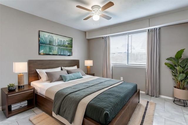 bedroom with ceiling fan and light tile patterned flooring