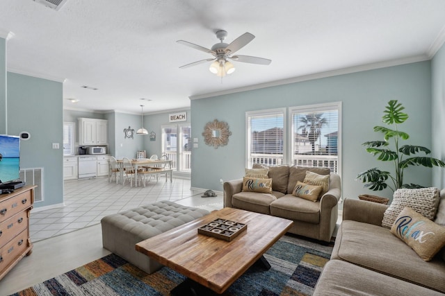 living room featuring ceiling fan, ornamental molding, and light tile patterned flooring