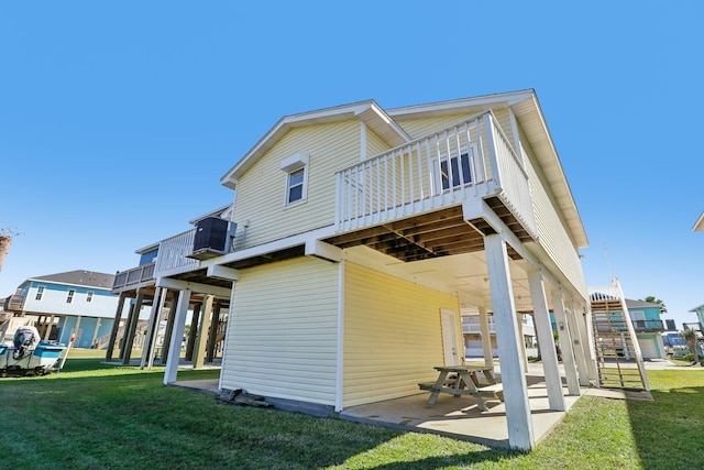 back of property featuring a yard, central air condition unit, and a patio area