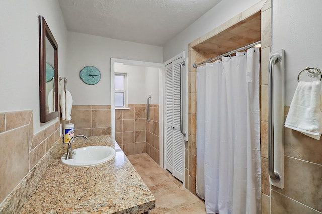 bathroom with tile walls and vanity