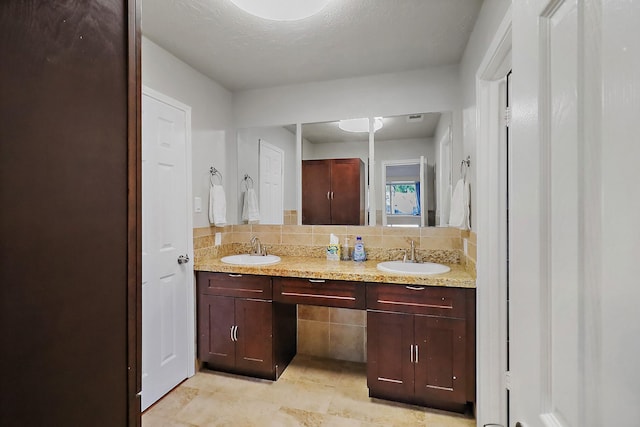 bathroom with decorative backsplash and vanity