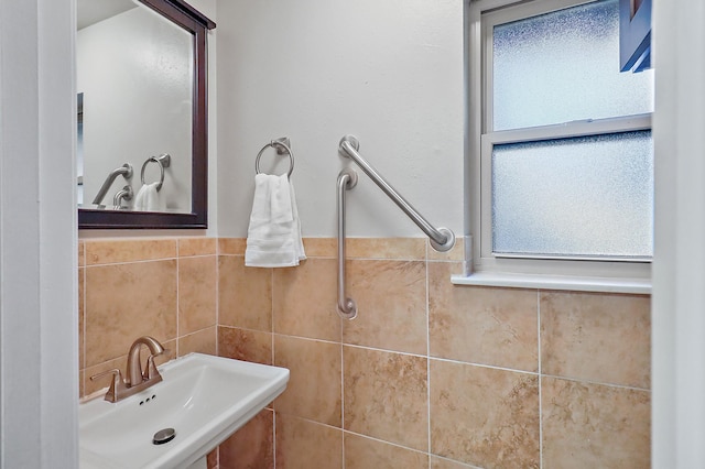 bathroom with tile walls and sink