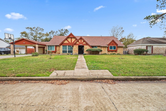 view of front of property featuring a garage, central AC unit, and a front yard