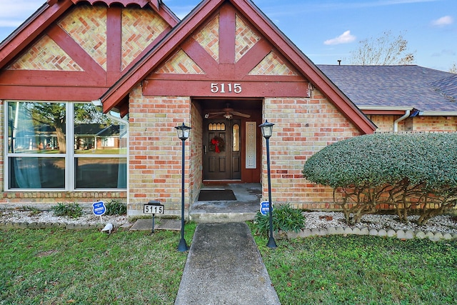 view of exterior entry featuring a lawn