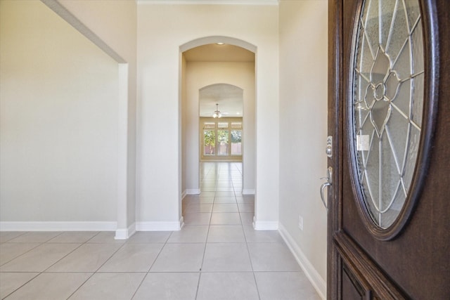 entryway with ceiling fan and light tile patterned floors