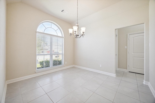 tiled empty room featuring lofted ceiling and an inviting chandelier