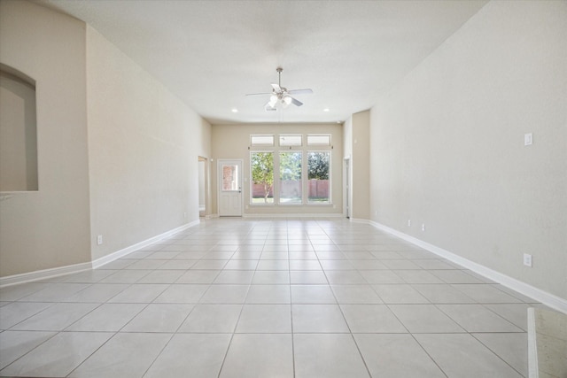 tiled spare room with ceiling fan