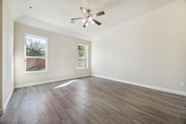 spare room with lofted ceiling, dark wood-type flooring, and ceiling fan