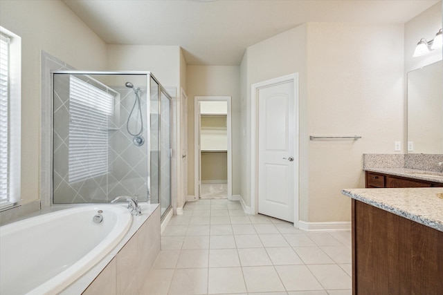 bathroom with vanity, tile patterned flooring, and plus walk in shower