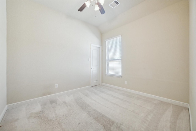 spare room with ceiling fan, light carpet, and lofted ceiling