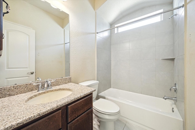 full bathroom featuring toilet, tiled shower / bath, tile patterned floors, and vanity