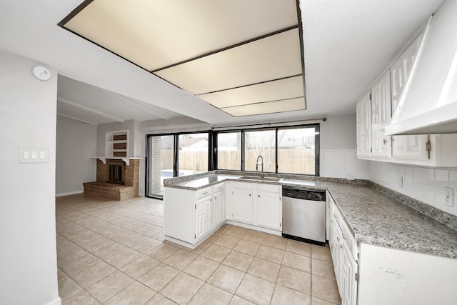 kitchen with dishwasher, light tile patterned floors, sink, white cabinetry, and tasteful backsplash