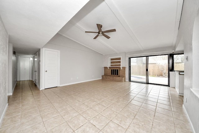 unfurnished living room featuring lofted ceiling, a brick fireplace, light tile patterned flooring, and ceiling fan