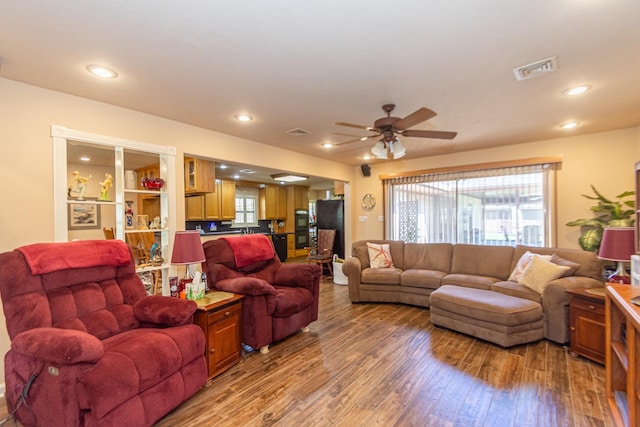 living room featuring ceiling fan and wood-type flooring