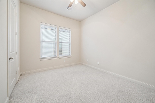 carpeted spare room with ceiling fan