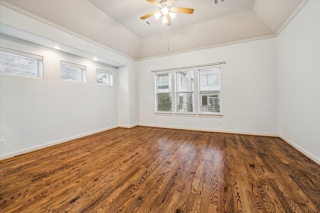 empty room featuring ceiling fan, lofted ceiling, a raised ceiling, and dark hardwood / wood-style floors