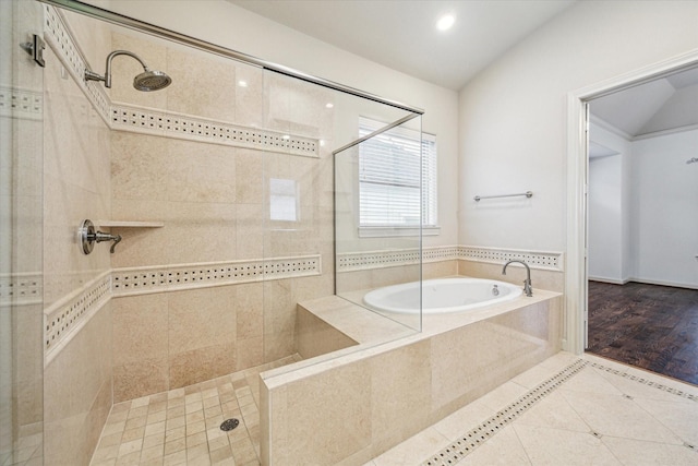 bathroom with shower with separate bathtub, tile patterned floors, and vaulted ceiling