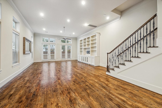 unfurnished living room featuring ceiling fan, hardwood / wood-style flooring, built in features, and ornamental molding