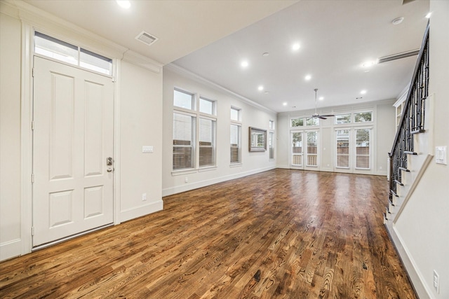 unfurnished living room with french doors, ornamental molding, ceiling fan, and dark hardwood / wood-style floors