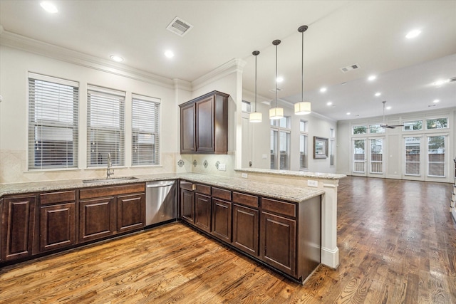 kitchen with dishwasher, kitchen peninsula, ceiling fan, sink, and decorative light fixtures