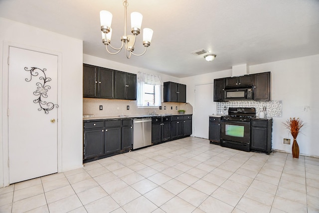 kitchen featuring tasteful backsplash, light tile patterned floors, black appliances, and a chandelier