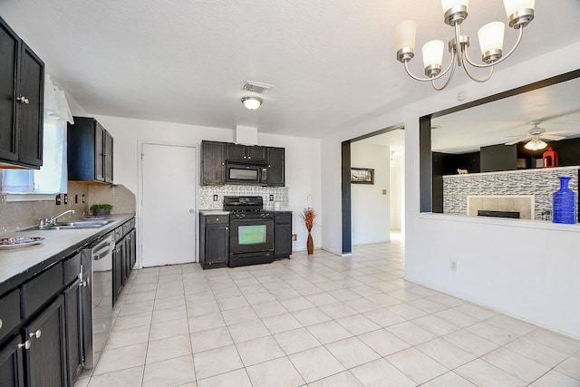 kitchen featuring hanging light fixtures, black appliances, tasteful backsplash, ceiling fan with notable chandelier, and sink