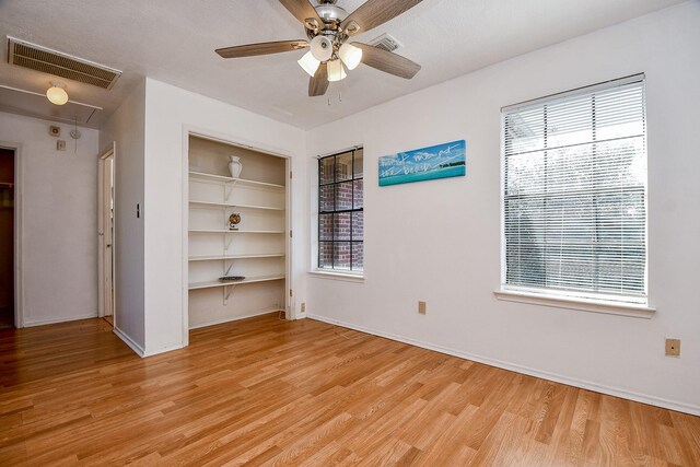 empty room featuring light wood-type flooring and ceiling fan