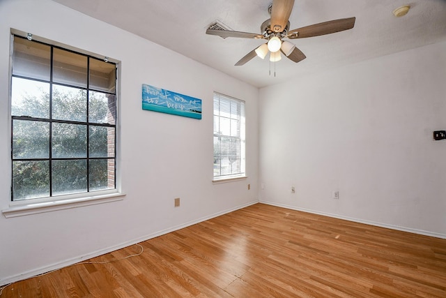 spare room with light hardwood / wood-style floors and ceiling fan