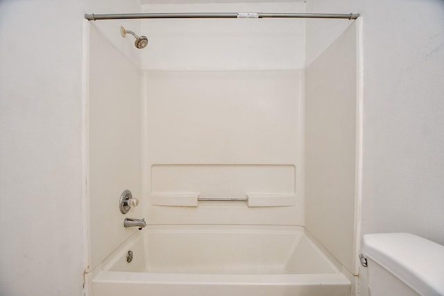 bathroom featuring toilet and shower / bathing tub combination