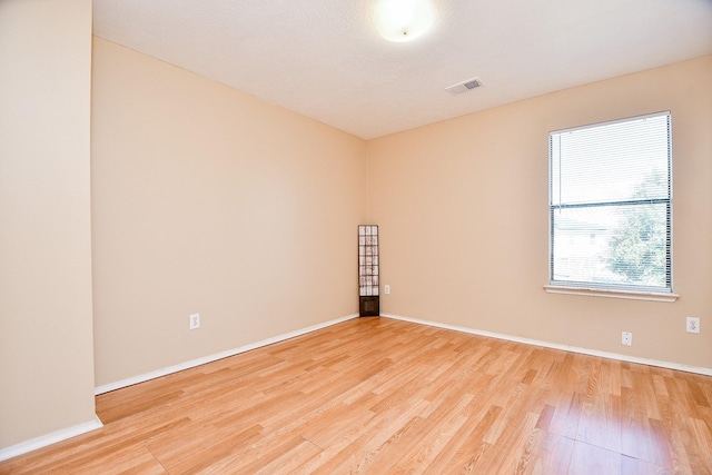 spare room featuring light wood-type flooring