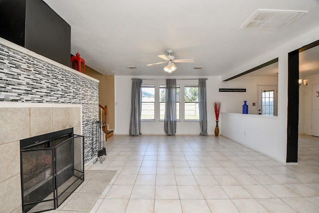 living room featuring ceiling fan, light tile patterned flooring, and a fireplace