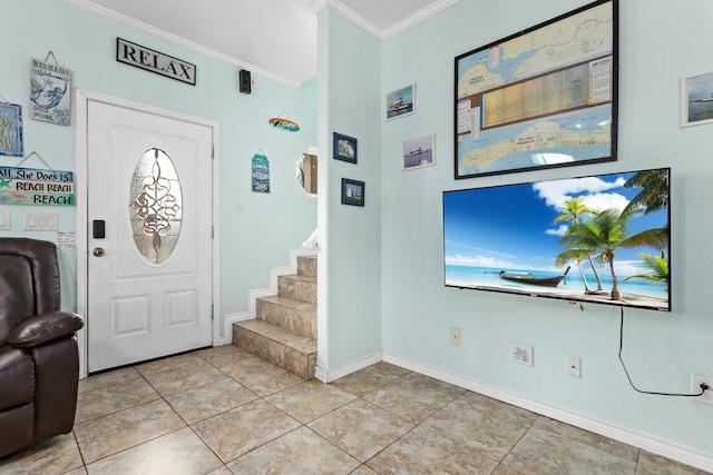 tiled foyer featuring ornamental molding