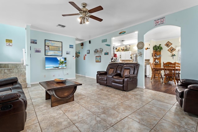 living room featuring ornamental molding, ceiling fan, and light tile patterned floors