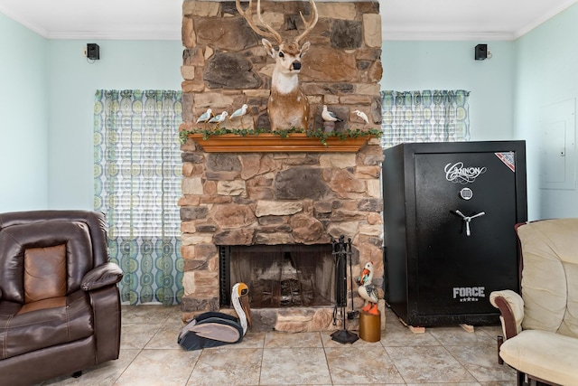 living room with light tile patterned floors, a fireplace, ornamental molding, and electric panel