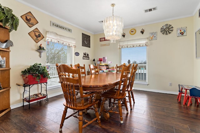 dining area with dark wood-type flooring, an inviting chandelier, and crown molding