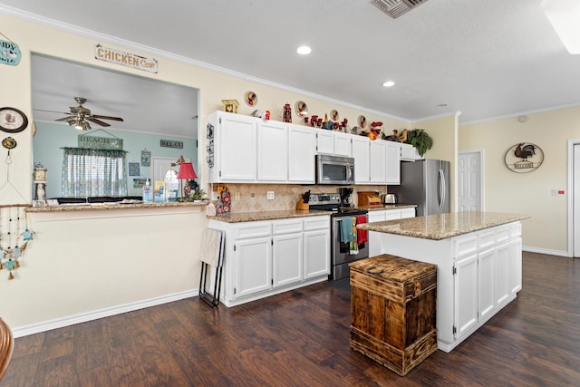 kitchen featuring stainless steel appliances, white cabinetry, crown molding, and kitchen peninsula