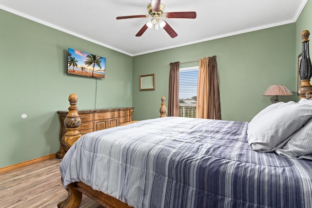 bedroom featuring ceiling fan, crown molding, and light hardwood / wood-style flooring