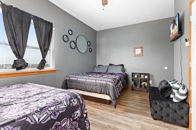 bedroom with light wood-type flooring and ceiling fan