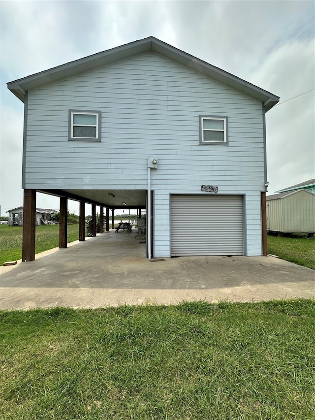 rear view of property with a yard and a carport