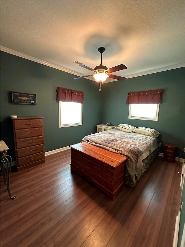 bedroom with ceiling fan, dark wood-type flooring, ornamental molding, and a textured ceiling