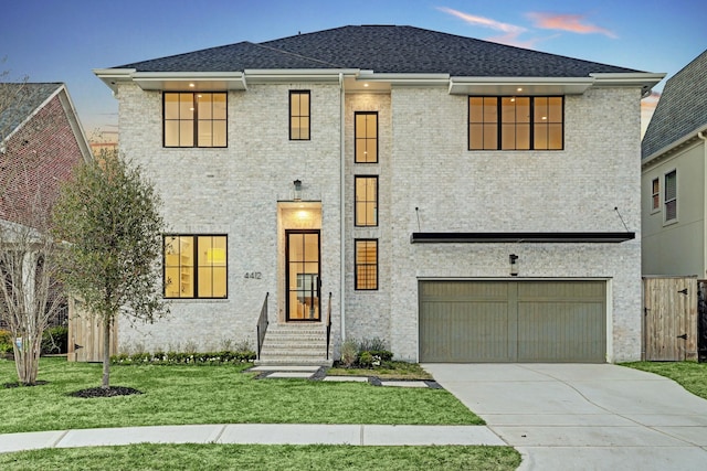 view of front of house with a yard and a garage