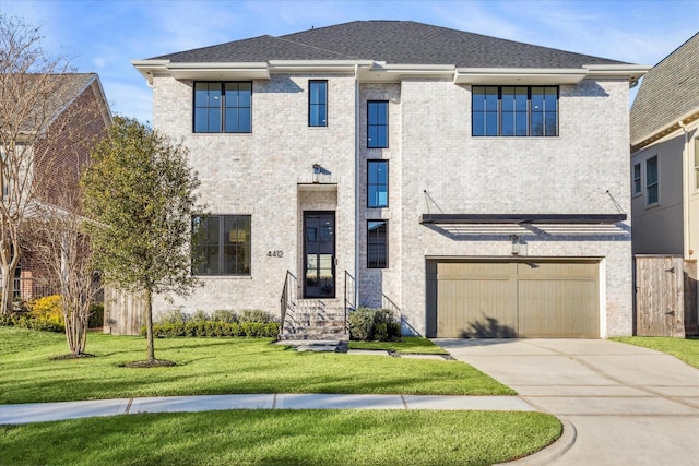 view of front facade with a garage and a front lawn