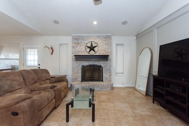 living room featuring lofted ceiling and a stone fireplace