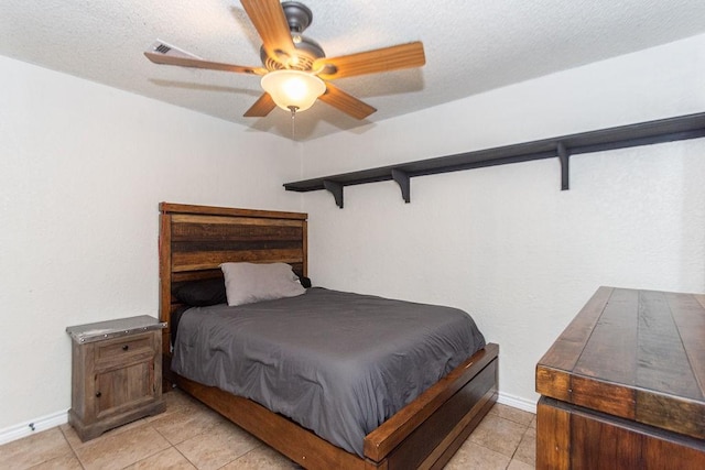 bedroom featuring light tile patterned flooring, a textured ceiling, and ceiling fan