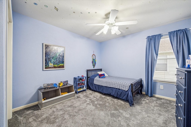 bedroom featuring ceiling fan and carpet