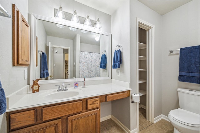 bathroom with vanity, tile patterned floors, and toilet