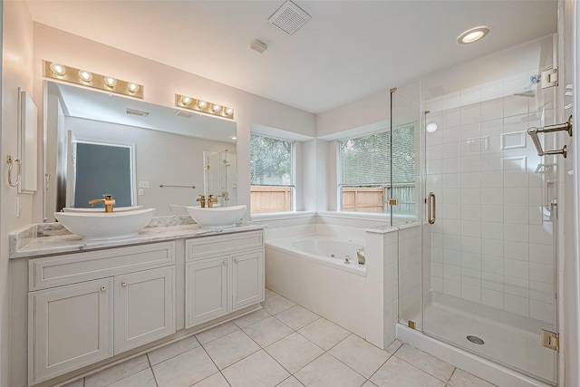 bathroom with tile patterned flooring, shower with separate bathtub, and vanity