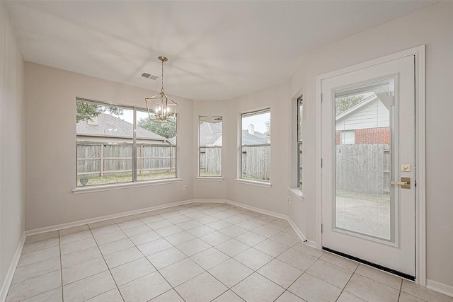 interior space featuring a notable chandelier and light tile patterned flooring