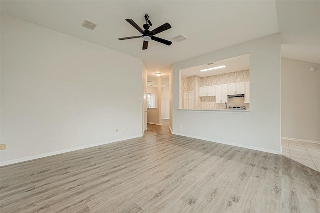 unfurnished living room with ceiling fan and light hardwood / wood-style floors