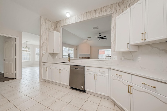 kitchen featuring white cabinets, ceiling fan, dishwasher, and lofted ceiling